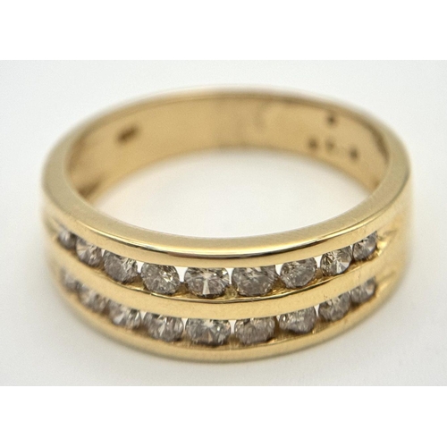 409 - An 18K Yellow Gold Two Row Diamond Ring. 18 channel set diamonds - 0.75ctw approx. Size P 1/2. 5.2g ... 