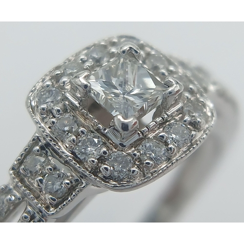 170 - A 14K WHITE GOLD DIAMOND SET SPLIT SHANK HALO RING 0.45CT CENTRE PRINCESS CUT DIAMOND. 0.20CT. 3.1G.... 