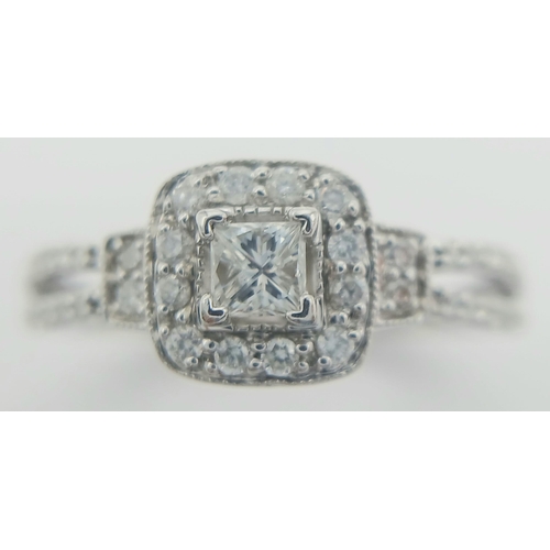 170 - A 14K WHITE GOLD DIAMOND SET SPLIT SHANK HALO RING 0.45CT CENTRE PRINCESS CUT DIAMOND. 0.20CT. 3.1G.... 