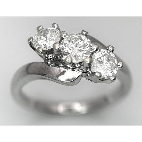 23 - AN 18K WHITE GOLD DIAMOND CROSSOVER TRILOGY RING. 1.20CT. 5G TOTAL WEIGHT. SIZE M. Ref: A/S 1195