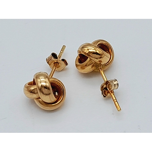 322 - Classic pair of 9 CARAT GOLD ‘KNOT’ STUD EARRINGS. Complete with backs.  0.43 grams.