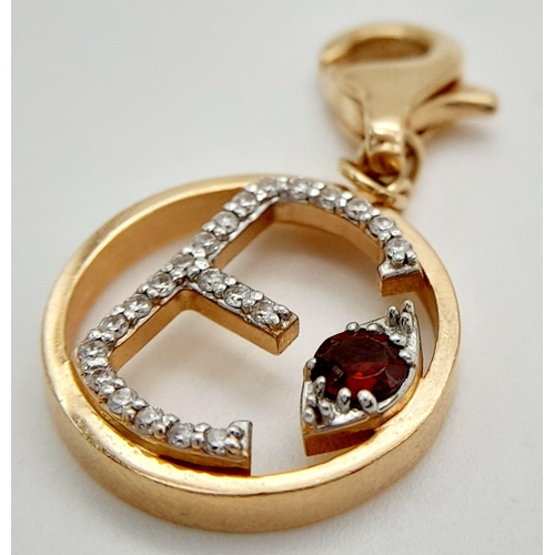 492 - A 14K ROSE GOLD DIAMOND & RUBY SET INITIAL E CHARM. 2.1G TOTAL WEIGHT. APPROX. 2.9CM IN LENGTH AND 1... 