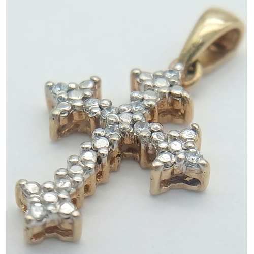 766 - A 9K YELLOW GOLD DIAMOND SET CROSS. 0.93G TOTAL WEIGHT. 2 X 1.2CM Ref: SC 1039