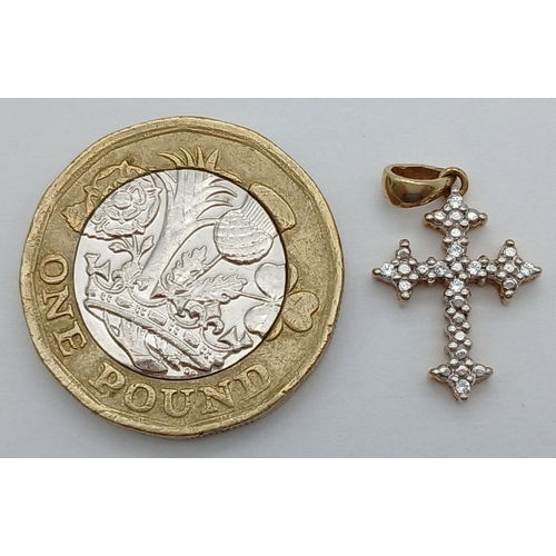 766 - A 9K YELLOW GOLD DIAMOND SET CROSS. 0.93G TOTAL WEIGHT. 2 X 1.2CM Ref: SC 1039