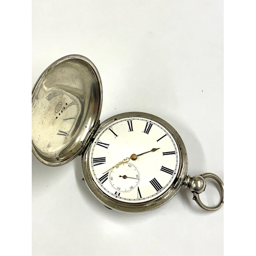 677 - An Antique silver full hunter pocket watch. In working order, ticks / stops , missing glass as found... 