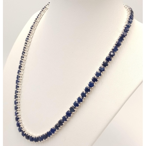 228 - A 925 sterling silver blue sapphire gemstone tennis necklace. Round-cut blue sapphire stones. Total ... 