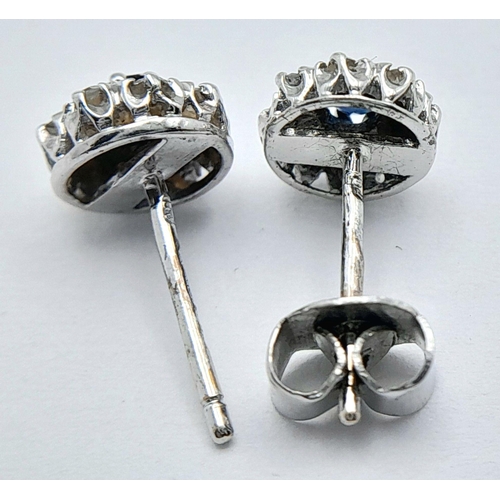 576 - A PAIR OF 9K WHITE GOLD DIAMOND & SAPPHIRE STUD EARRINGS. 1.34G TOTAL WEIGHT. needs one new butterfl... 