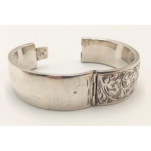 620 - A Vintage Hallmarked 1945 Silver Scroll Detail Clip Lock Bangle. 5.8cm Inner length. Gross Weight 30... 