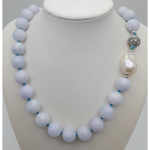 643 - An Aquamarine Large Beaded Necklace with Baroque Pearl Interrupter. Beads - 14mm. Necklace length - ... 