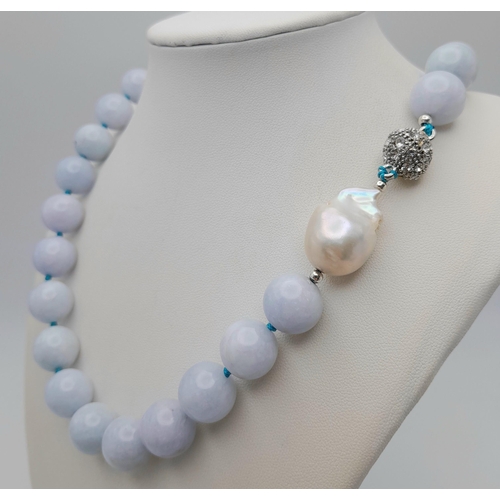 643 - An Aquamarine Large Beaded Necklace with Baroque Pearl Interrupter. Beads - 14mm. Necklace length - ... 