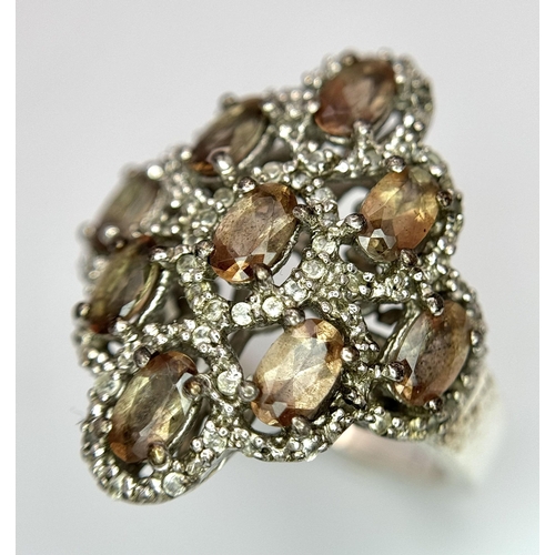 943 - An Art Deco Design Sterling Silver Grossular Garnet and Clear Stone Ring Size P. The Ring Measures 2... 