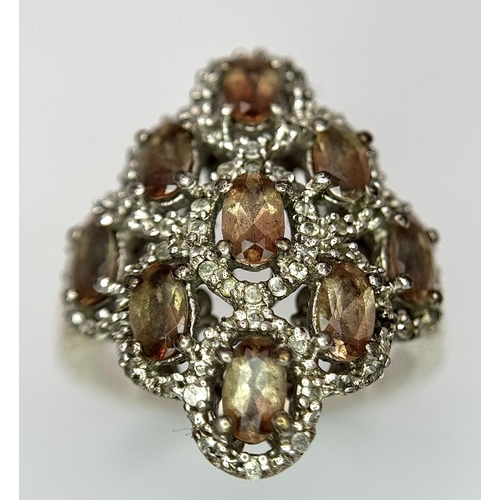 943 - An Art Deco Design Sterling Silver Grossular Garnet and Clear Stone Ring Size P. The Ring Measures 2... 