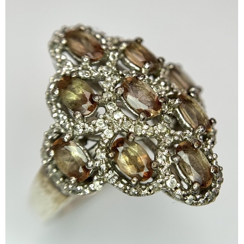 943 - An Art Deco Design Sterling Silver Grossular Garnet and Clear Stone Ring Size P. The Ring Measures 2... 