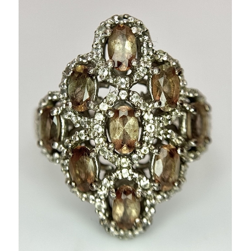 943 - An Art Deco Design Sterling Silver Grossular Garnet and Clear Stone Ring Size P. The Ring Measures 2... 