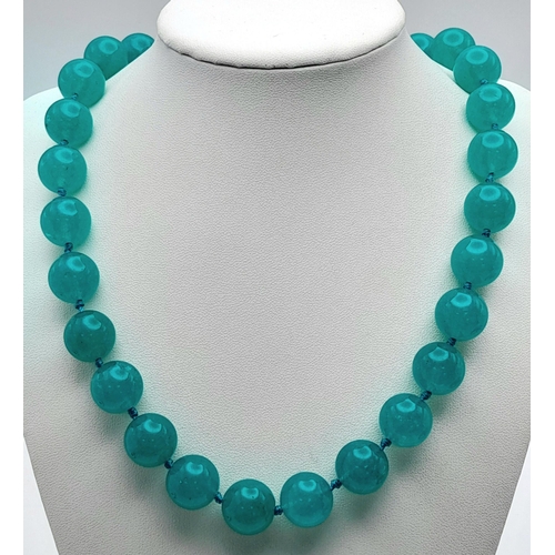 945 - A Large Blue Jade Beaded Necklace. 14mm beads. Necklace length - 46cm.