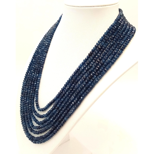 271 - A magnificent, seven row necklace with faceted dark blue sapphire rondelles. Length: 43-54 cm, weigh... 