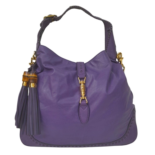 1192 - A Gucci Purple Leather Jackie Tote Bag. Decorated with bamboo tassels and gold tone hardware. Remova... 