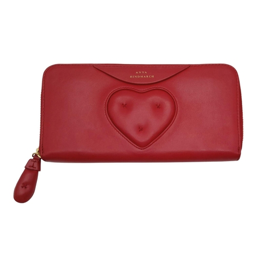 1094 - An Anya Hindmarch Clutch Purse/Wallet. Red leather exterior with quilted heart. Zipped and open comp... 