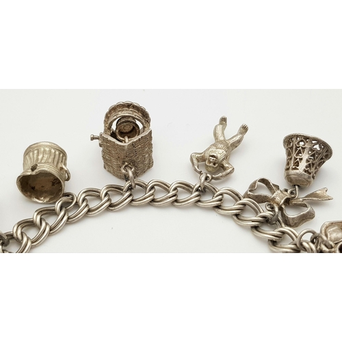 1085 - A vintage Solid Silver 925 Charm Bracelet, with 9 charms, 50.4 grams, 18.5cm, Heart padlock and safe... 