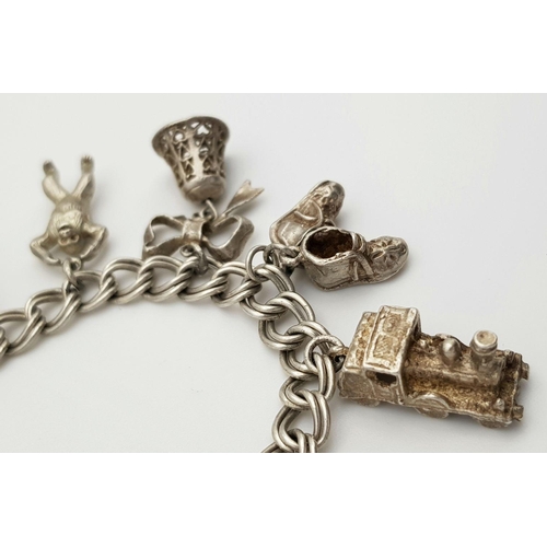 1085 - A vintage Solid Silver 925 Charm Bracelet, with 9 charms, 50.4 grams, 18.5cm, Heart padlock and safe... 