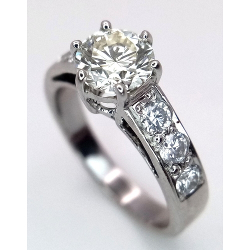 1296 - A 14K White Gold, Head-Turning Fancy Diamond Ring. A 1ct brilliant round cut yellow diamond with 0.6... 