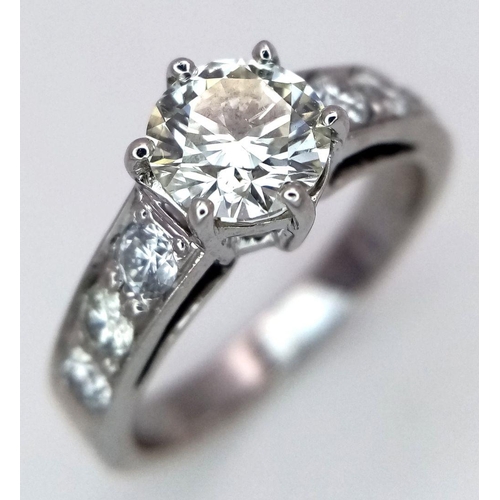 1296 - A 14K White Gold, Head-Turning Fancy Diamond Ring. A 1ct brilliant round cut yellow diamond with 0.6... 