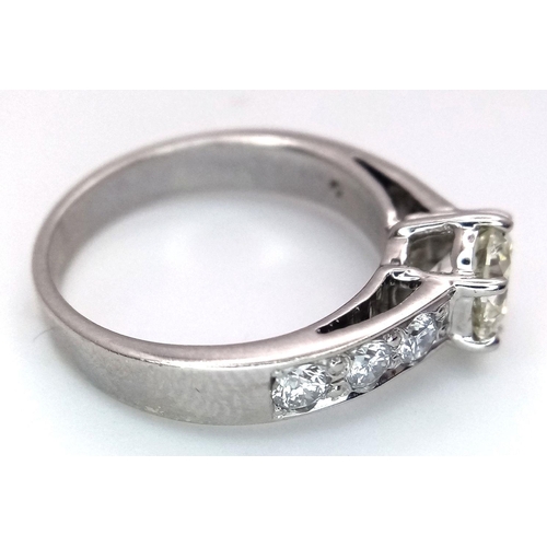 1296 - A 14K White Gold, Head-Turning Fancy Diamond Ring. A 1ct brilliant round cut yellow diamond with 0.6... 