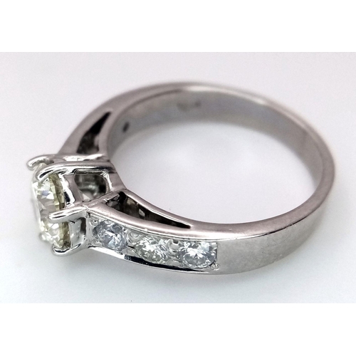 1296 - A 14K White Gold, Head-Turning Fancy Diamond Ring. A 1ct brilliant round cut yellow diamond with 0.6... 