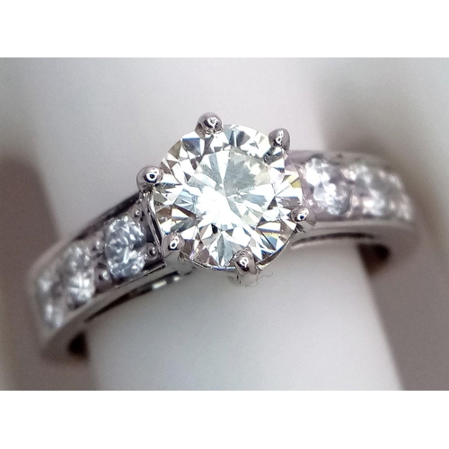 1296 - A 14K White Gold, Head-Turning Fancy Diamond Ring. A 1ct brilliant round cut yellow diamond with 0.6... 