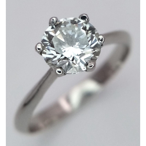 1303 - A Platinum Diamond Solitaire Ring. A 1.25ct Brilliant round cut diamond - SI1 clarity. Size P. 4g to... 