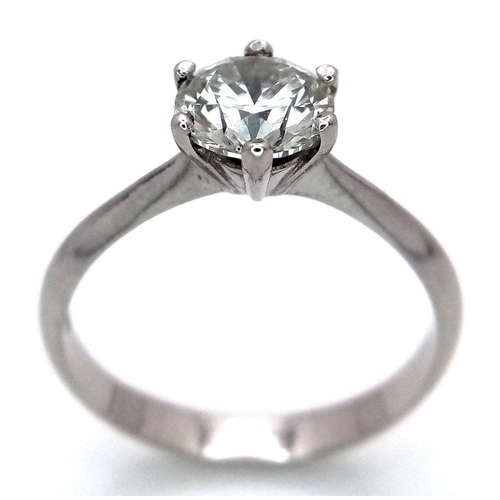 1303 - A Platinum Diamond Solitaire Ring. A 1.25ct Brilliant round cut diamond - SI1 clarity. Size P. 4g to... 