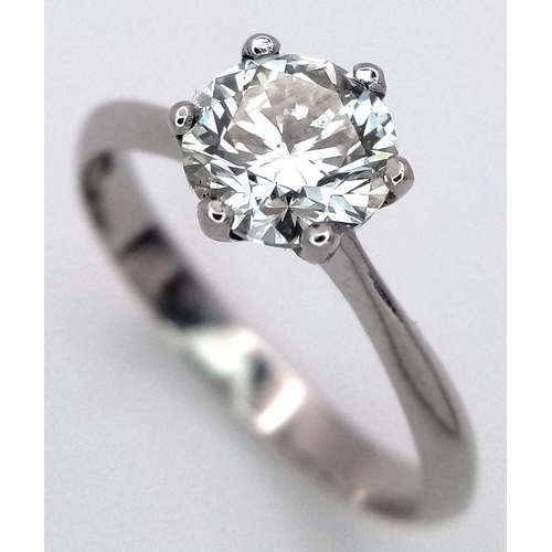 1303 - A Platinum Diamond Solitaire Ring. A 1.25ct Brilliant round cut diamond - SI1 clarity. Size P. 4g to... 