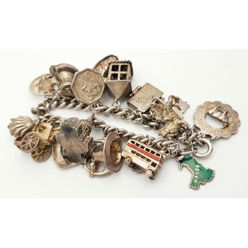 145 - A Vintage Solid Silver 925 Charm Bracelet, with 19 charms, 86 grams, 18.5cm. In good condition.