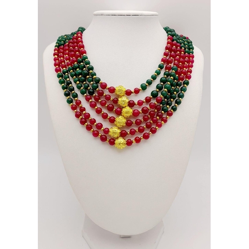 257 - A substantial six row necklace with green and red jade highly polished beads in a geometric design, ... 