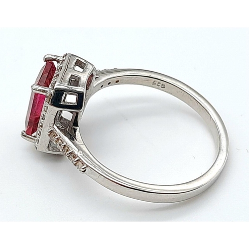 277 - A 925 silver ring featuring a 2ct emerald-cut pink tourmaline, surrounded by a halo of diamonds and ... 