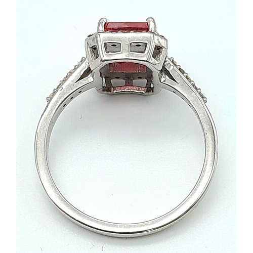 277 - A 925 silver ring featuring a 2ct emerald-cut pink tourmaline, surrounded by a halo of diamonds and ... 