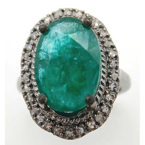 284 - A 6cts Oval Emerald Set Ring with halo of Diamond accents, Diamond weight approx 0.30ct. Ring size M... 