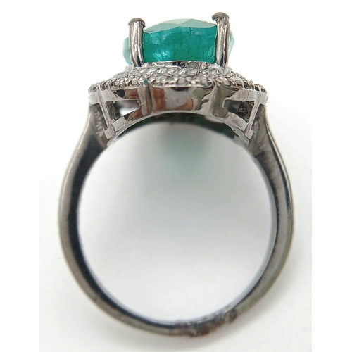 284 - A 6cts Oval Emerald Set Ring with halo of Diamond accents, Diamond weight approx 0.30ct. Ring size M... 