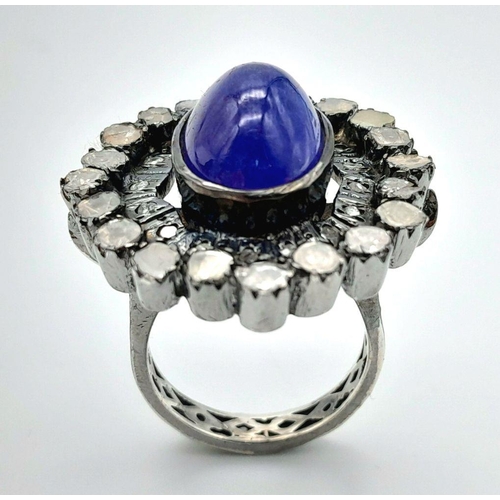 291 - A 925 silver tanzanite ring featuring a striking 9ct oval-cut tanzanite gemstone at its centre, surr... 