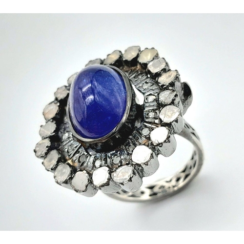 291 - A 925 silver tanzanite ring featuring a striking 9ct oval-cut tanzanite gemstone at its centre, surr... 