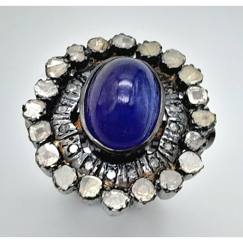 291 - A 925 silver tanzanite ring featuring a striking 9ct oval-cut tanzanite gemstone at its centre, surr... 