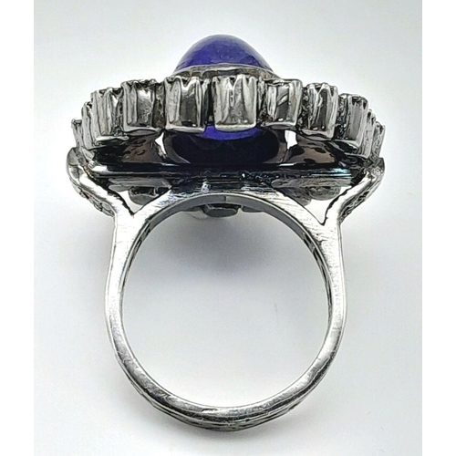 291 - A 925 silver tanzanite ring featuring a striking 9ct oval-cut tanzanite gemstone at its centre, surr... 