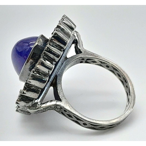 291 - A 925 silver tanzanite ring featuring a striking 9ct oval-cut tanzanite gemstone at its centre, surr... 