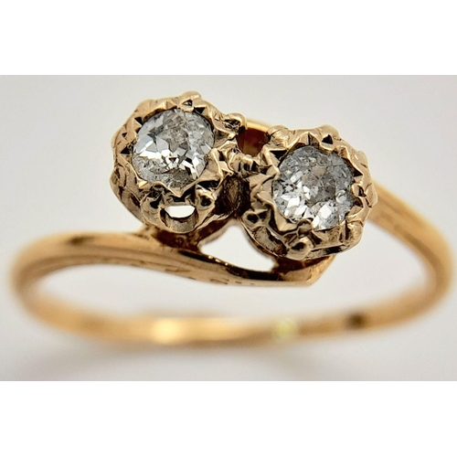 300 - A 14K Yellow Gold Diamond Crossover Ring. 0.40ctw of brilliant round cut diamonds. Size L. 2.3g tota... 