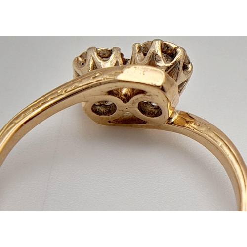 300 - A 14K Yellow Gold Diamond Crossover Ring. 0.40ctw of brilliant round cut diamonds. Size L. 2.3g tota... 