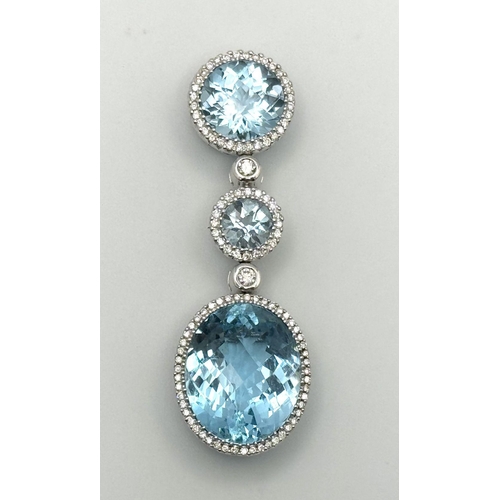 38 - A Gorgeous London Topaz and Diamond Pendant. 15ctw of Round and Oval Cut Ice Blue Topaz with Diamond... 