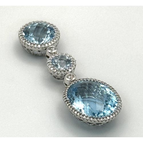 38 - A Gorgeous London Topaz and Diamond Pendant. 15ctw of Round and Oval Cut Ice Blue Topaz with Diamond... 