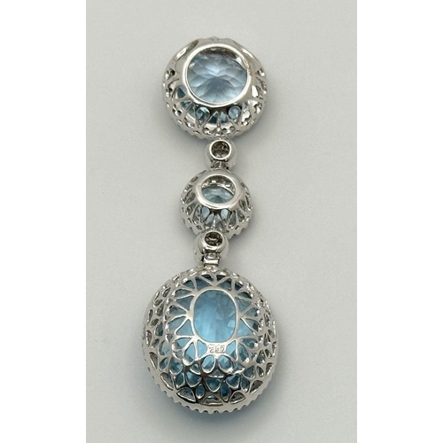 38 - A Gorgeous London Topaz and Diamond Pendant. 15ctw of Round and Oval Cut Ice Blue Topaz with Diamond... 