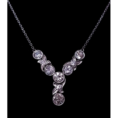 708 - An Art Deco Platinum and Diamond Lavaliere Necklace. 3.2ctw of old European round cut diamonds with ... 