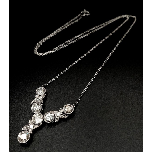 708 - An Art Deco Platinum and Diamond Lavaliere Necklace. 3.2ctw of old European round cut diamonds with ... 